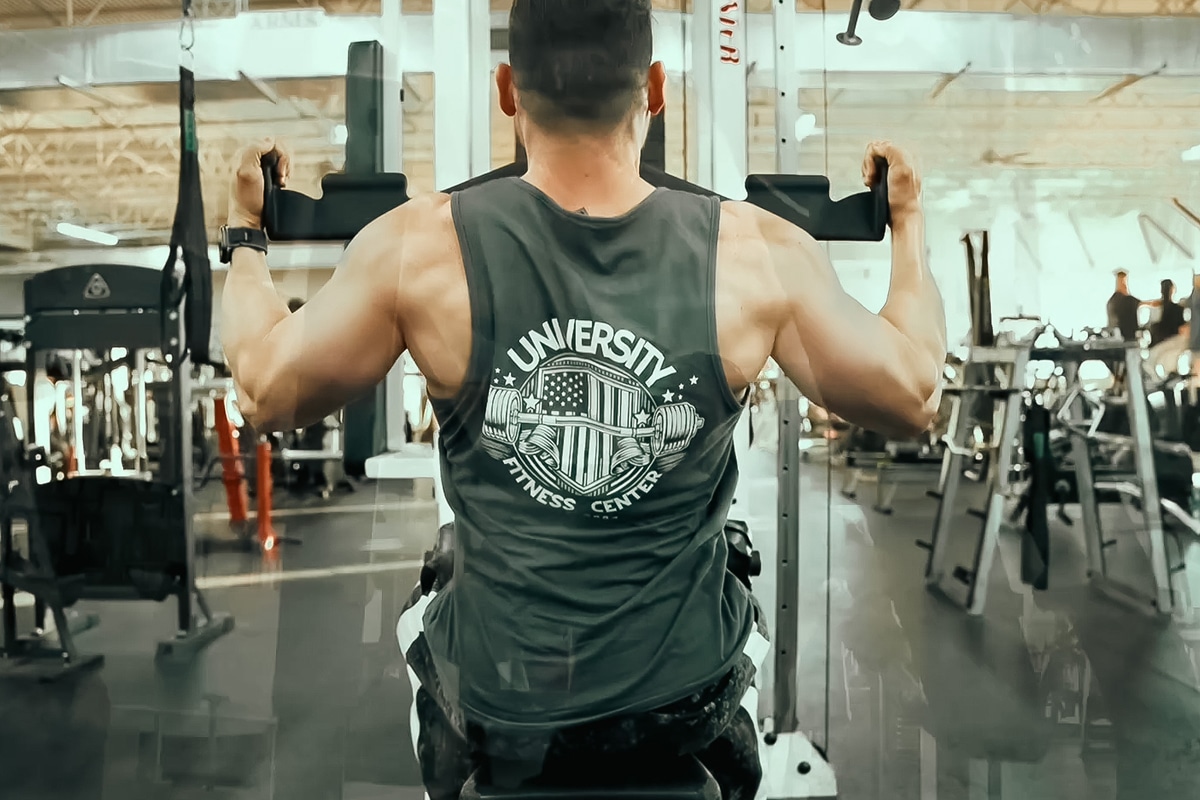 Gym member wearing University tank top performing back workout.